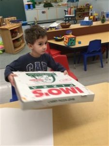 Kid with Imo's pizza box