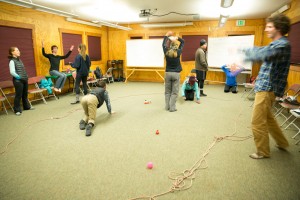Playing a game of blind dodgeball for communication and team-building.