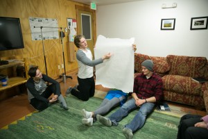 Josh holds their group's art while Nate explains what they did.