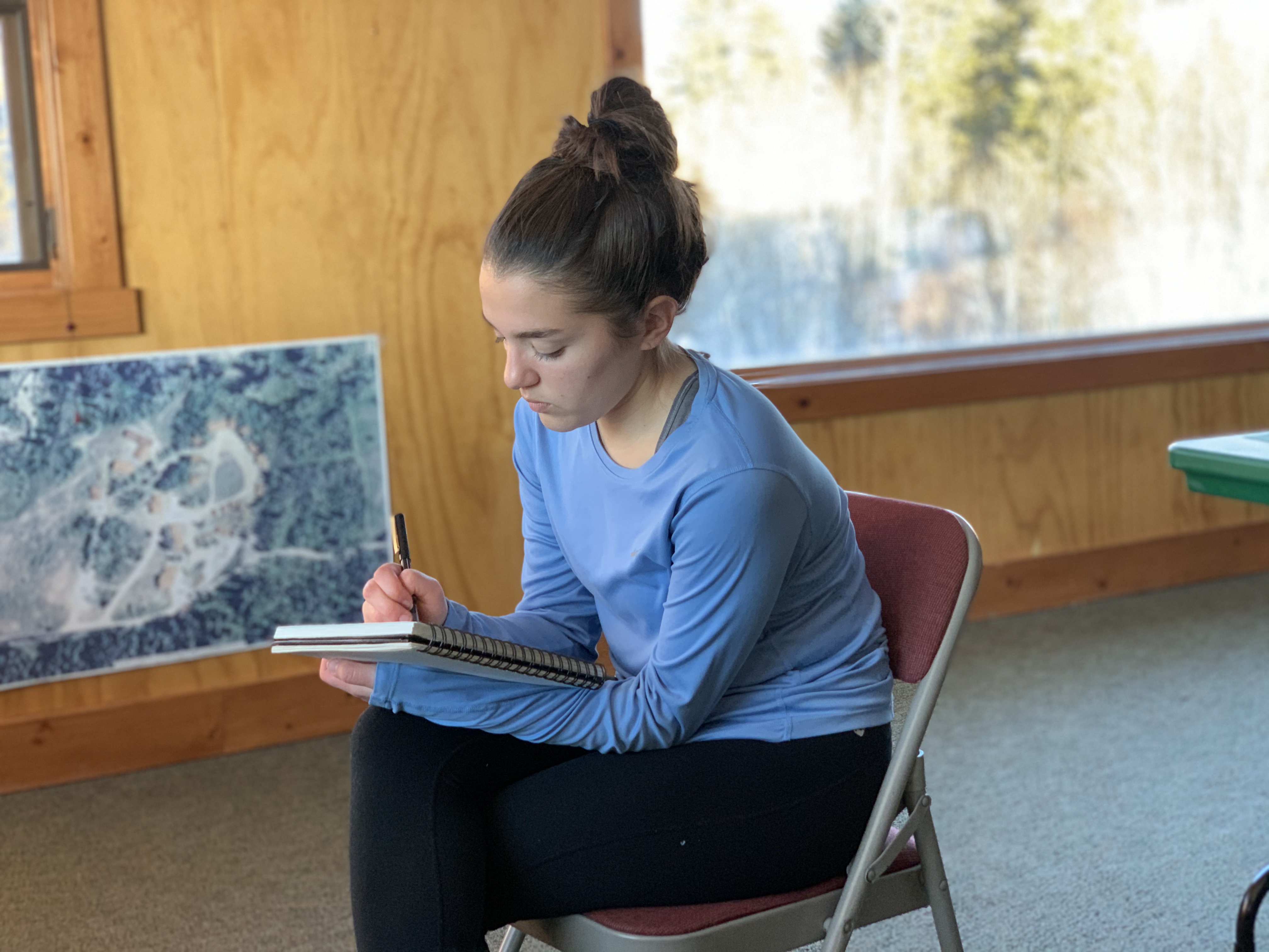 Jocelyn capturing the Tetons in her journal